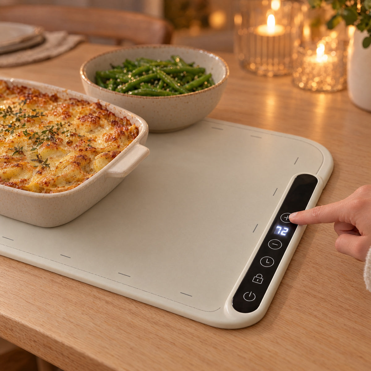 The digital control panel on the Lunna warming mat, with a display and push buttons, keeping dinner warm
