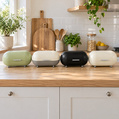 The bread bin in green, grey, black and white on the kitchen benchtop